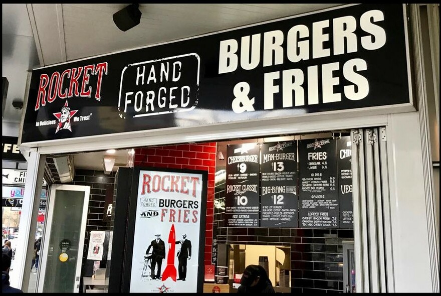 Rocket Burgers exterior with signage and menu displays.