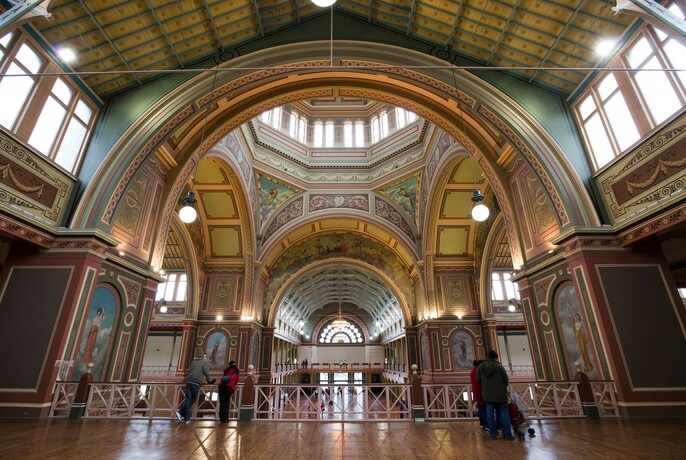 Ornately-painted arches and high windows Inside the World Heritage-listed Royal Exhibition Building.