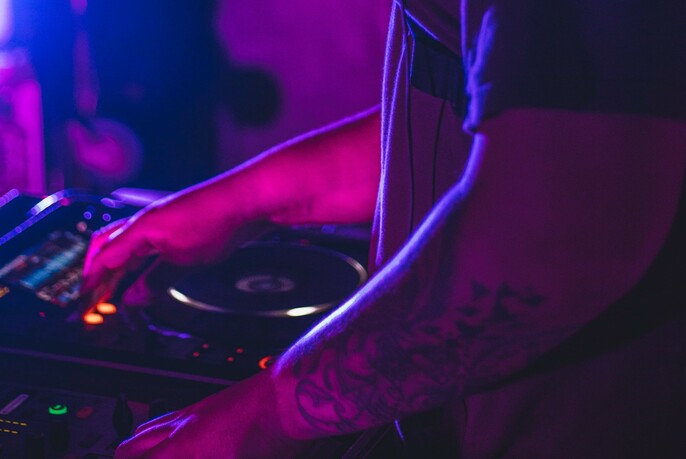 DJ in purple light.