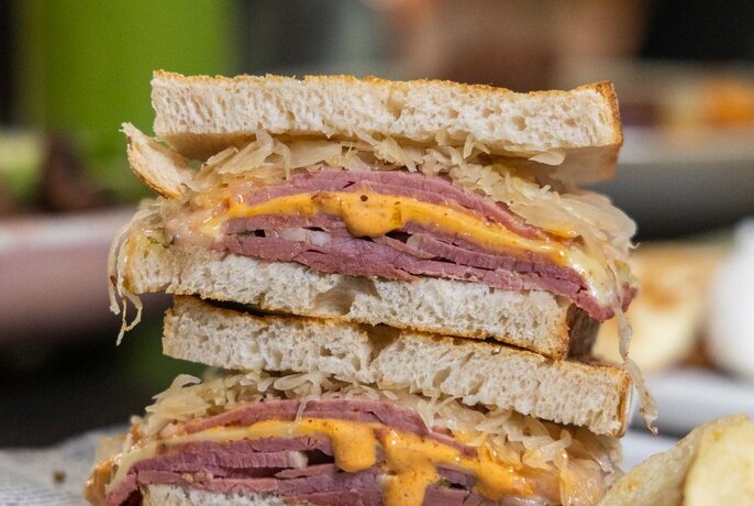 A stack of sandwiches with meat and cheese