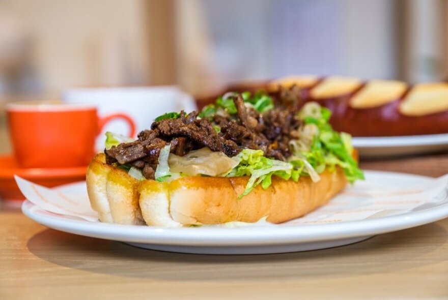 An open beef bulgogi sandwich on a cafe table.