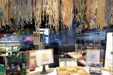 Shop interior with hanging pasta up top.