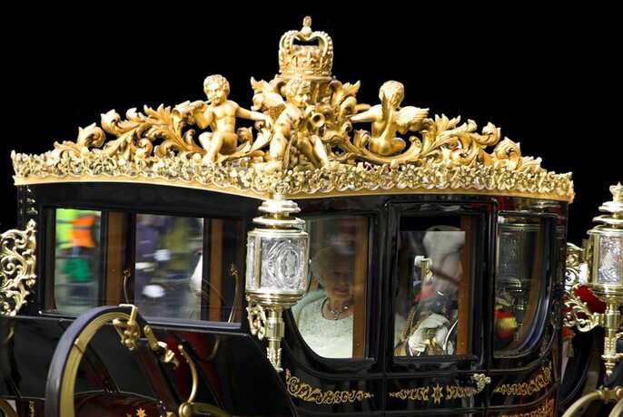 Detail of the Queen travelling in her royal coach.