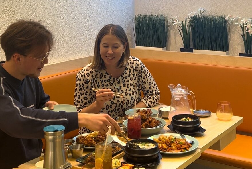 Two friends are eating a Korean lunch
