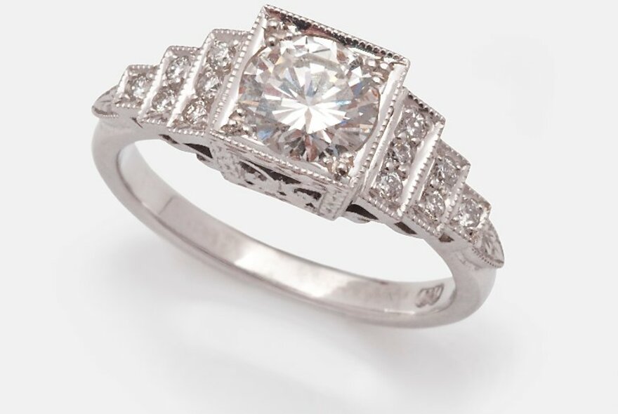 A platinum and diamond art deco ring with a multi-tiered setting.