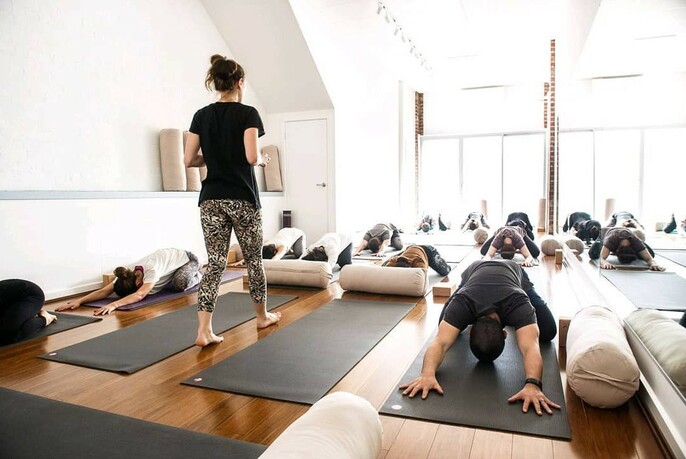 People doing yoga on mats.
