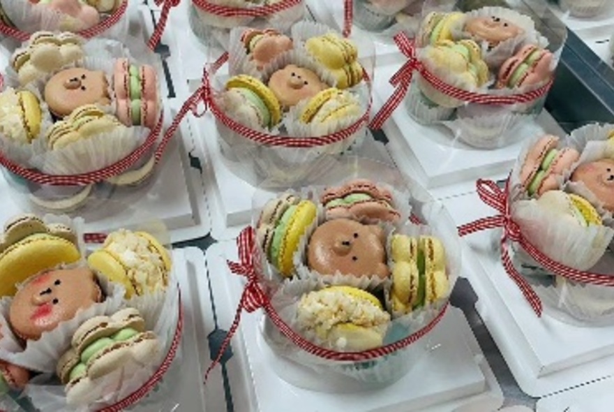 Dessert boxes filled with pastel-coloured macaroons.