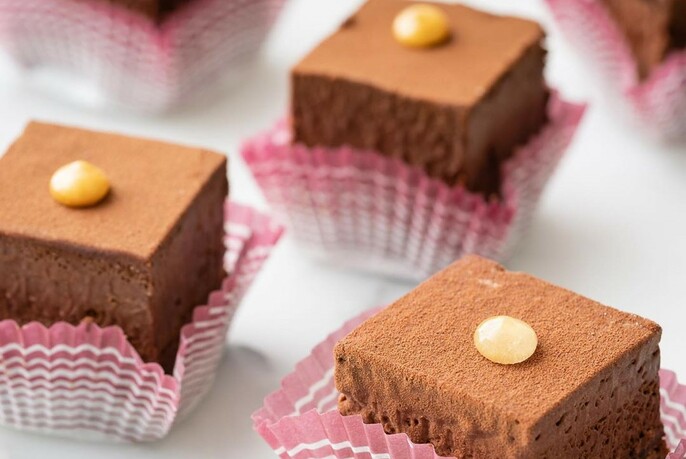 Individual cubes of chocolate mousse cake.