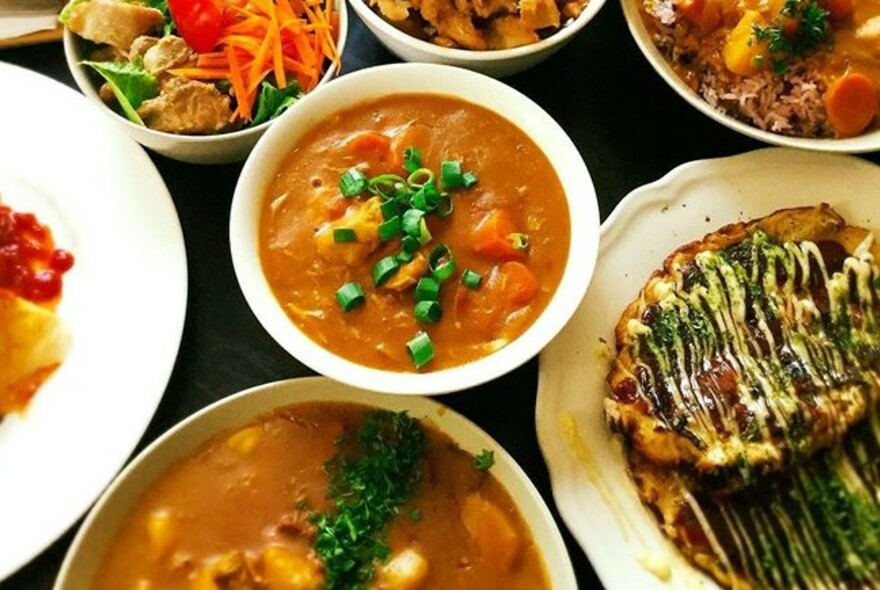 Collection of Japanese dishes including curries, pancake and salads.