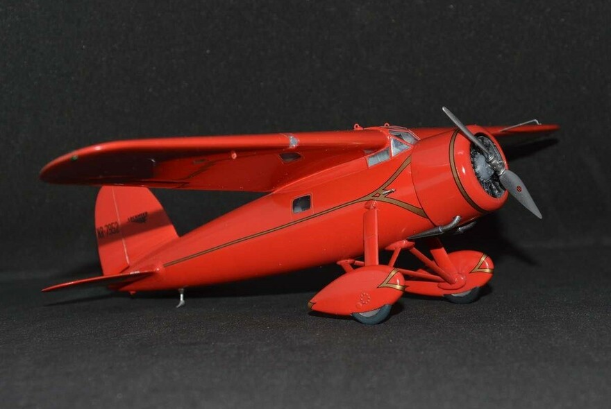 Red model propeller-driven aeroplane.
