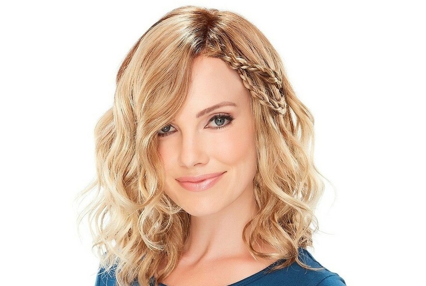 Model wearing blonde wig with braids.