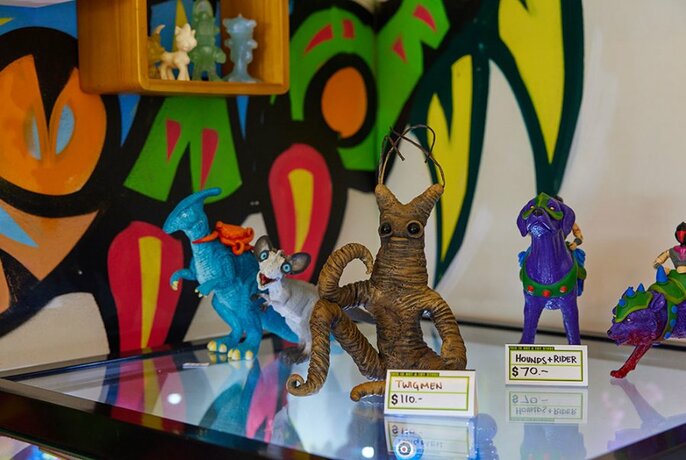 Brightly coloured imaginary creature models in a toy store.