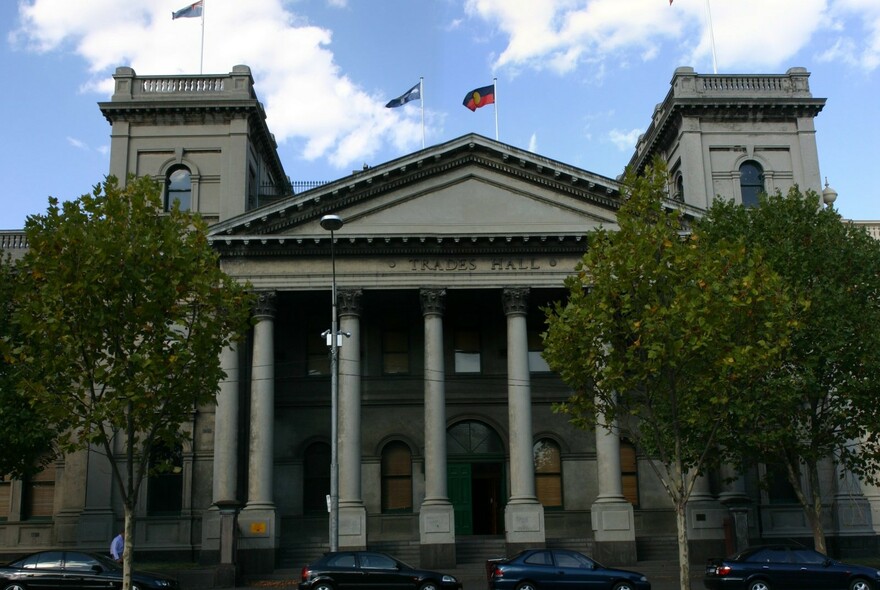 Columns and pediment of neoclassical Trades Hall building.