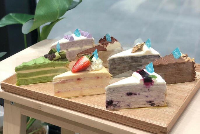 Slices of multi-layered cake from a range of different mille crepes cakes.