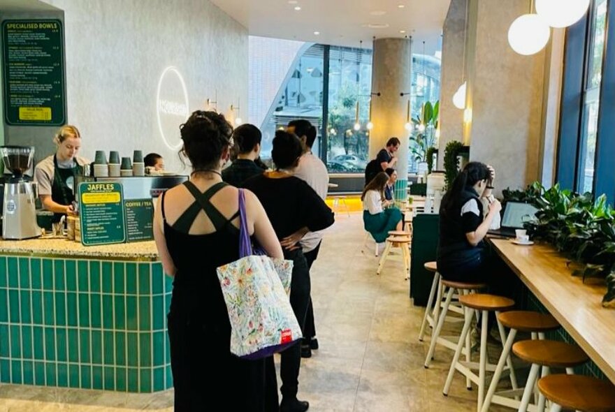 Customers queueing for meals in a cafe.