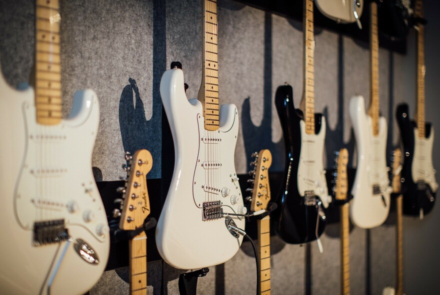 Guitars hanging on a wall.