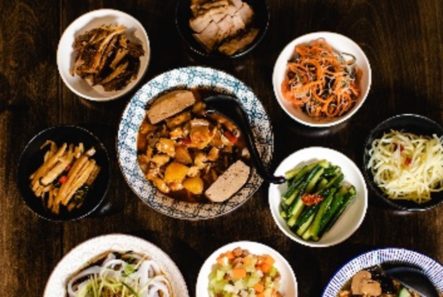 Bird's-eye view of assortment of dishes in different-sized bowls.