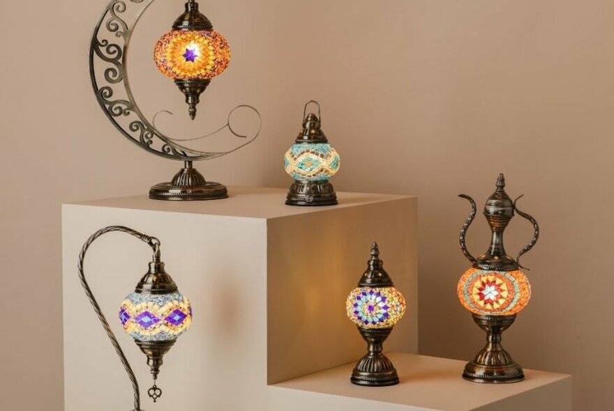 A collection of Turkish lamps on a display shelf.