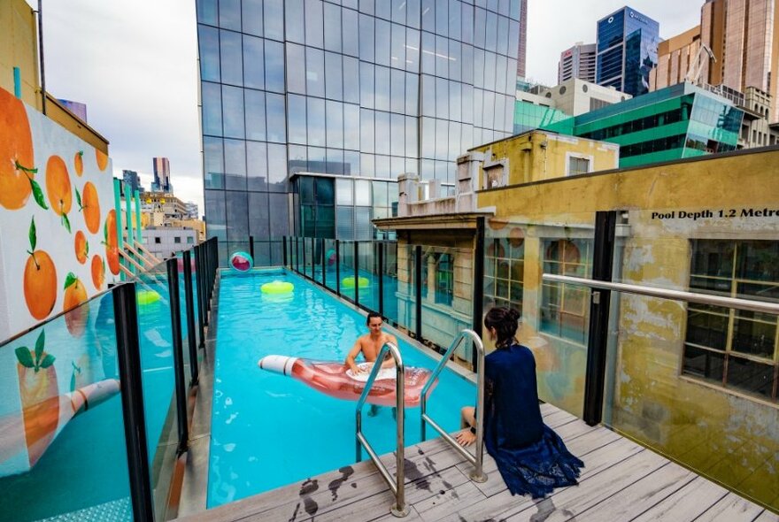Two people in rooftop pool