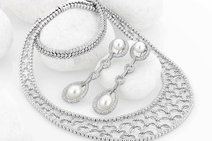 Platinum diamond and pearl earrings and necklace.
