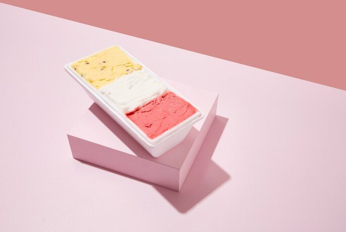 A tub containing three different flavours of gelato. 