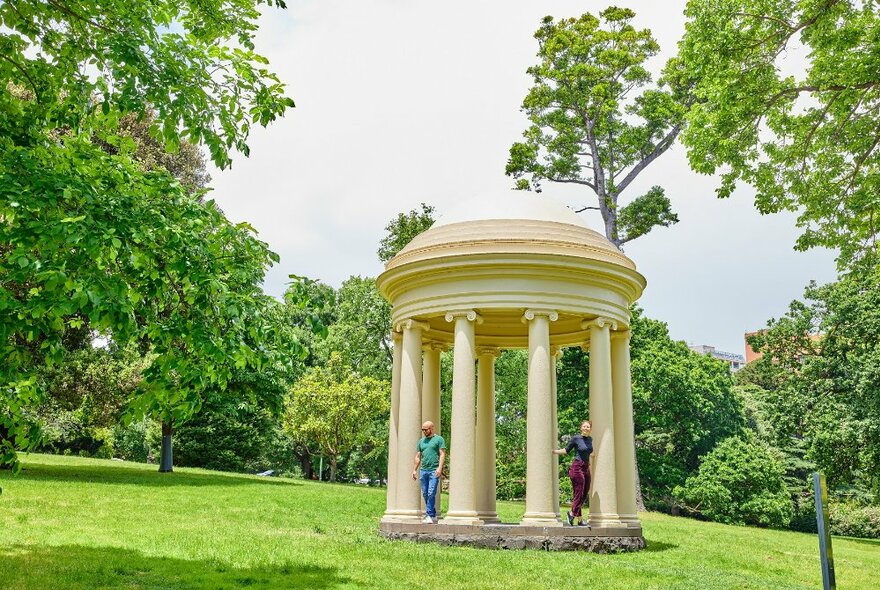 Two people standing in the Rotunda in Fitzroy Gardens. 