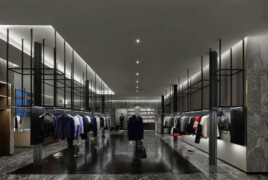 Clothing showroom with mannequin in middle and two rows of men's clothing either side.