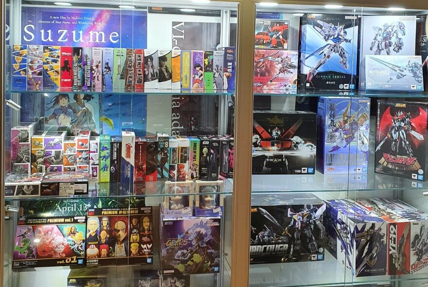 Glass-fronted display cabinet of anime products.
