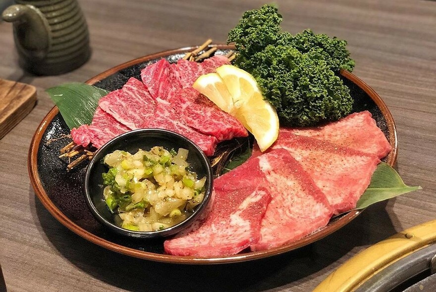 Plate with meat, pickles and parsley.