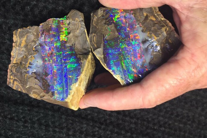 Two rocks with bright opal stripes.