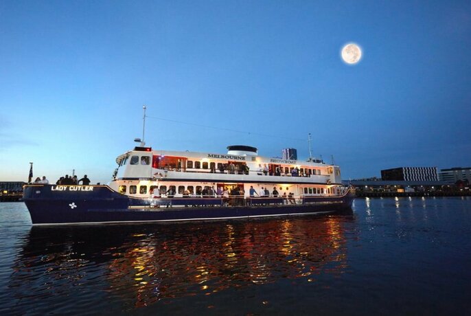 Lady Cutler boat cruising on the Yarra river with a full moon in the sky above.