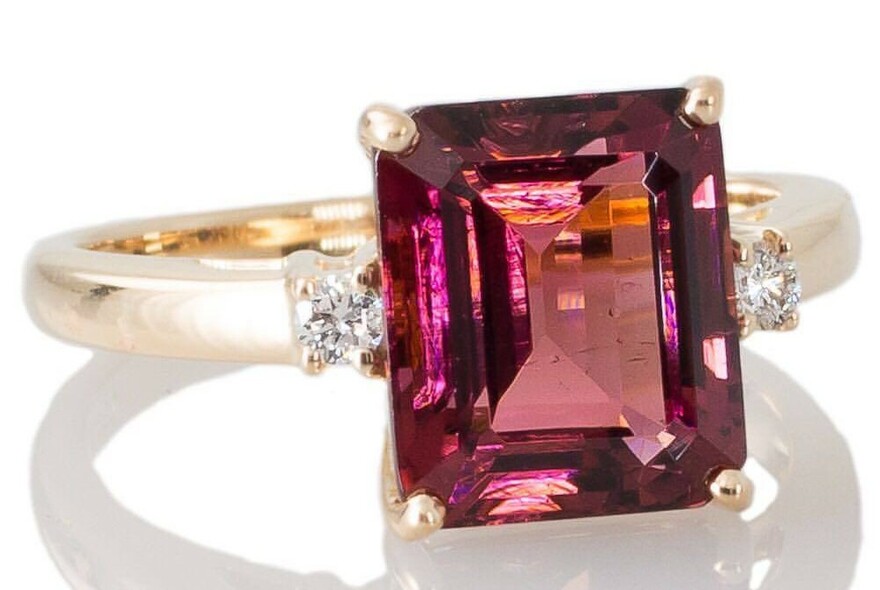 Gold ring with large square-cut deep pink stone and diamonds.