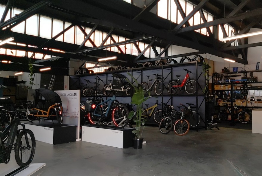 Sparque showroom showing many bikes on display in a high ceilinged warehouse space.