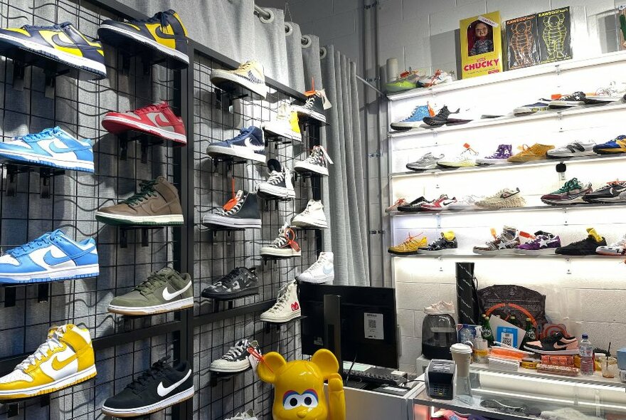 Store displaying sneakers on shelves.