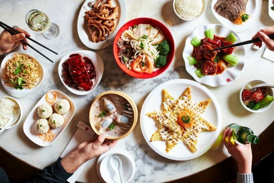 Chinese food on plates on a table.