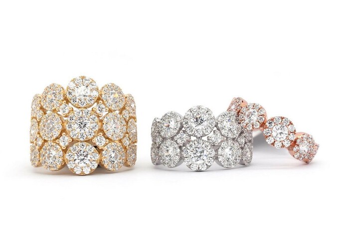 Three artificial diamond rings in gold, silver and rose gold.