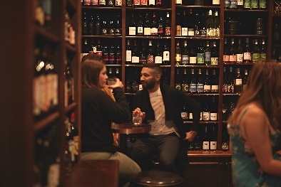 People drinking in a bottle store.