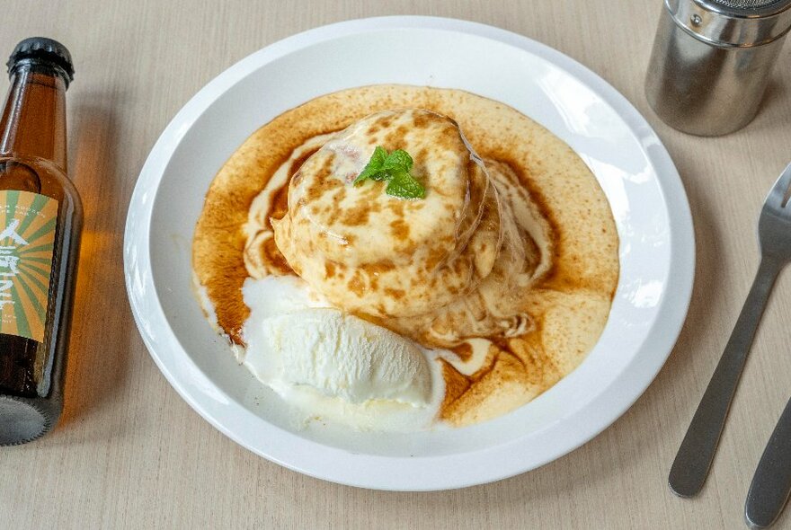Souffle-style pancakes on a plate with cream.