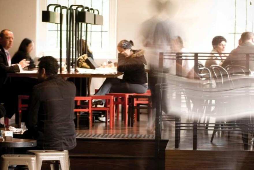 People seated inside a modern-looking cafe.