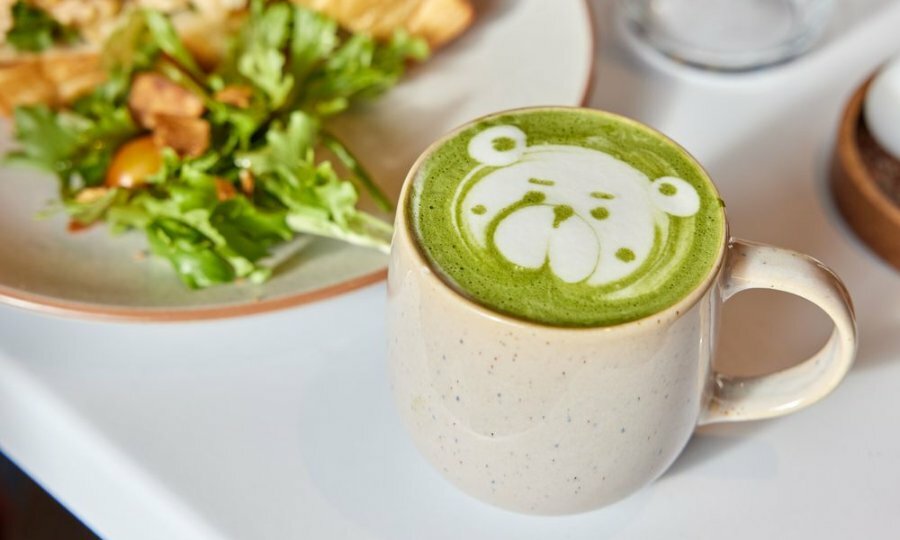 A green tea latte with latte art