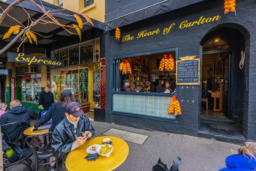 People sitting in front of a cafe