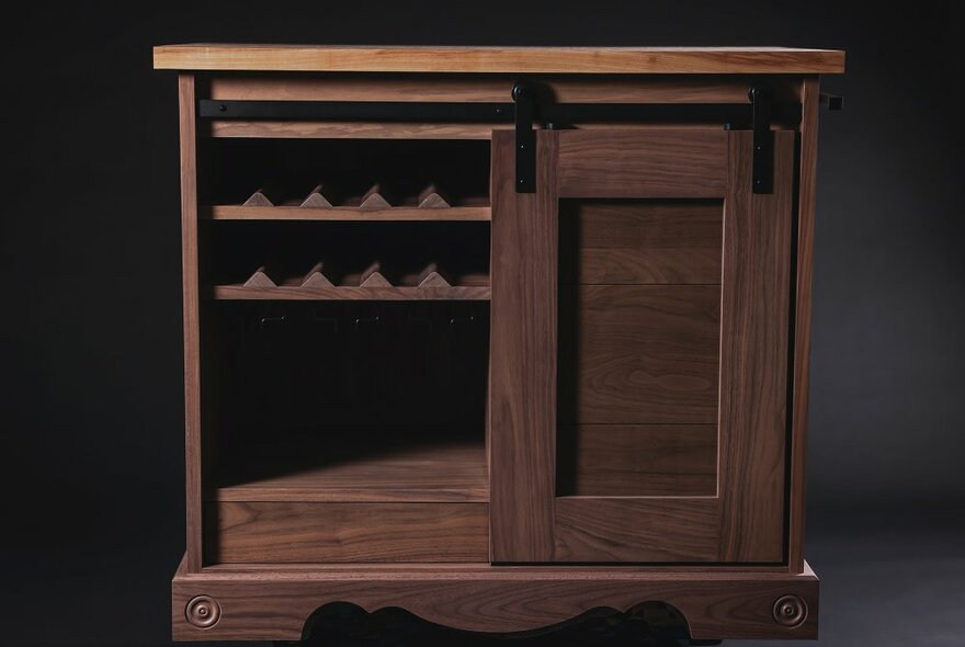 A wooden hand-crafted cabinet with internal shelves.