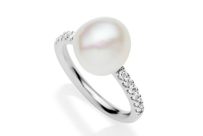 Large pearl ring with diamonds in silver band.