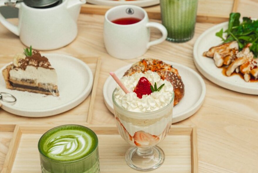 A selection of Japanese-inspired desserts with a matcha latte in the foreground.