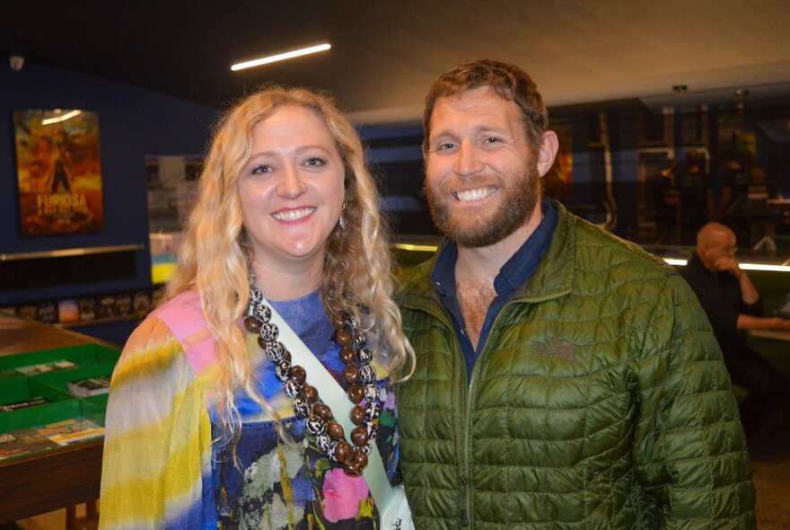 A man and a woman smiling at the camera.