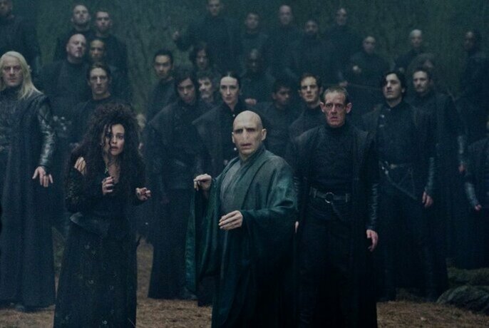A crowd of Harry Potter characters including Valdemort standing in a group and looking startled.