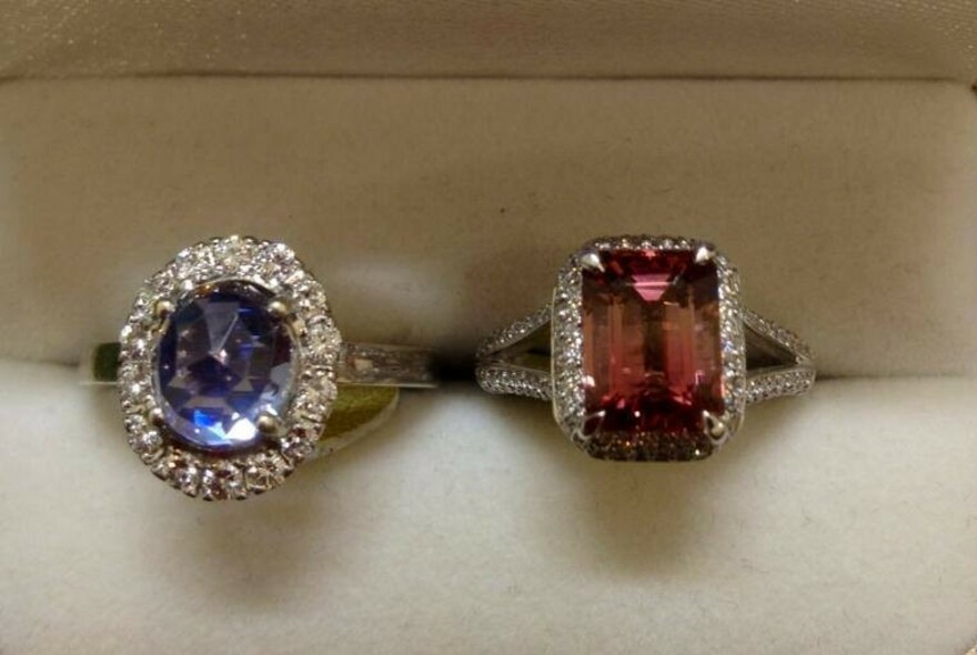 Two diamond rings with blue and pink gemstones.