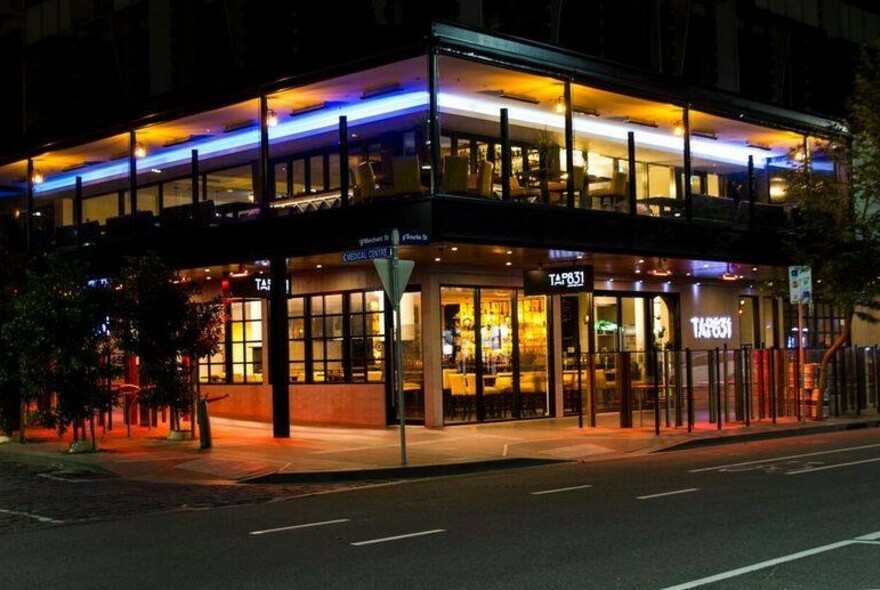 Modern, two-storey restaurant at night.