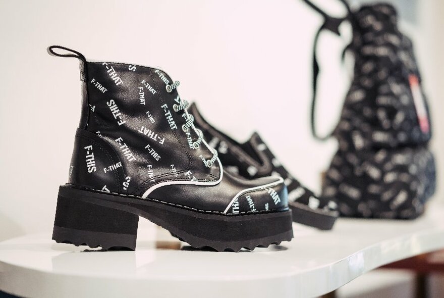 A chunky heel designer lace-up boot on display in a store.