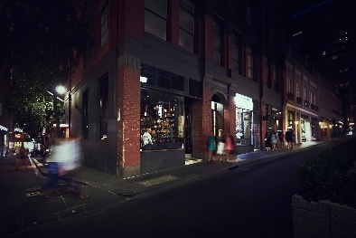 Street view of Bijou Bottle Store at night.